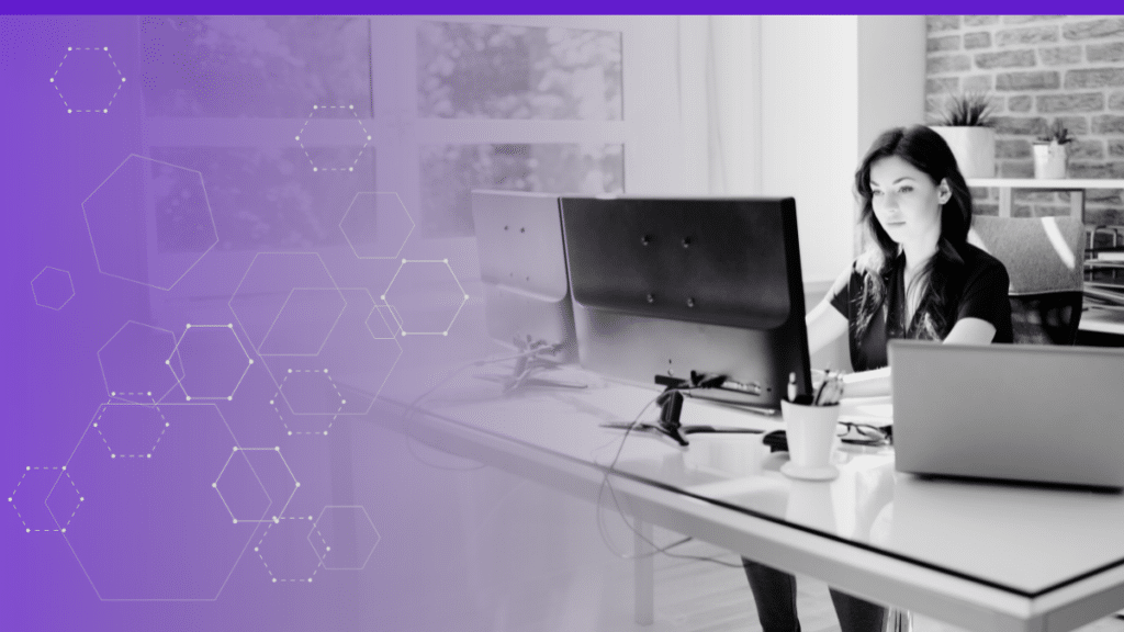 Woman working at a desk with multiple computer monitors, symbolizing productivity and focus in a modern office environment, with abstract hexagon graphics on a purple gradient background indicating technology and innovation.