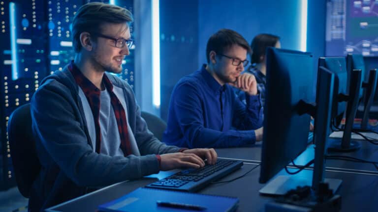 Two IT experts working help desk services.