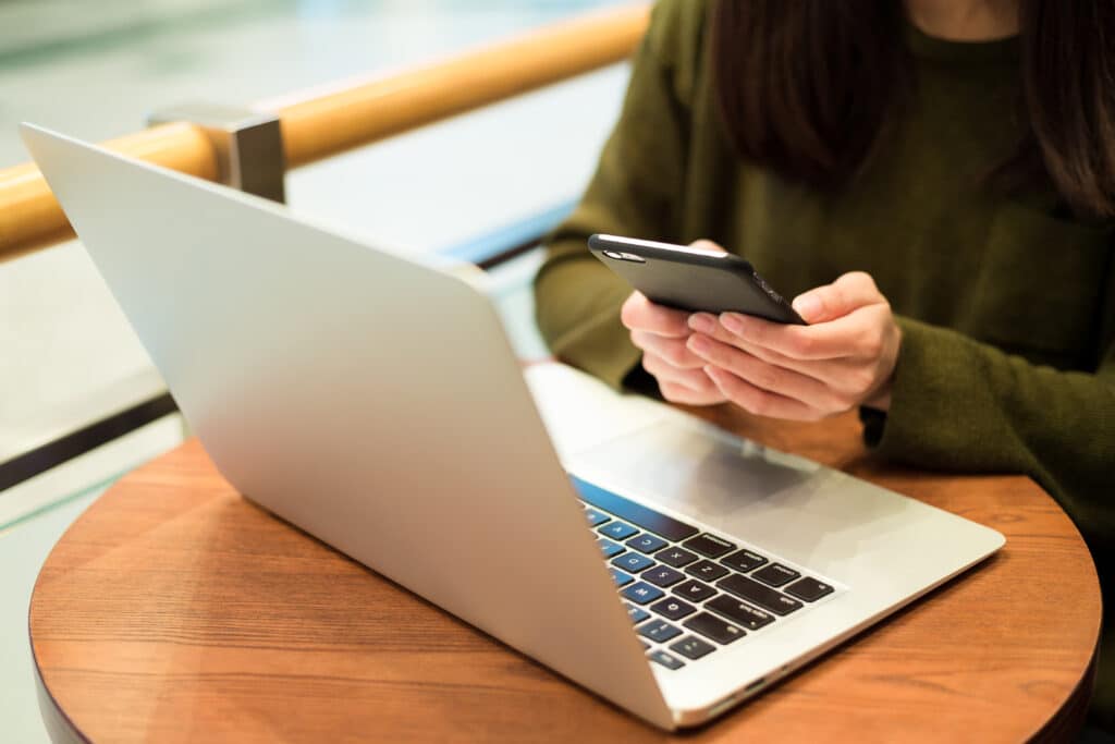 A women on multiple mobile devices, working remotely