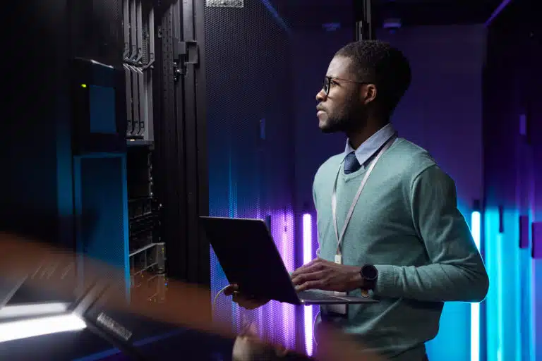 A man surveying his server room, setting up his domain controller.