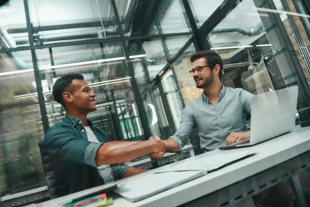 An HR professional greeting a new employee during onboarding